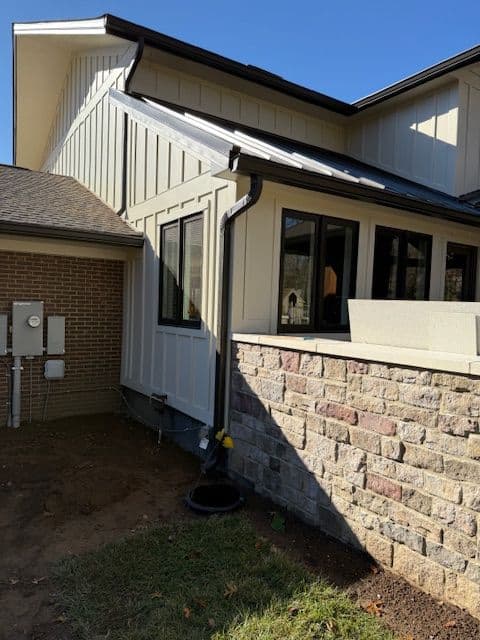 Modern home exterior showcasing stonework, siding, and energy-efficient utilities.